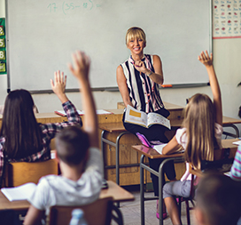 Teacher in class full of students