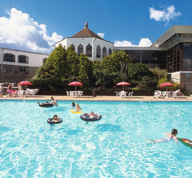 People in holiday park swimming pool