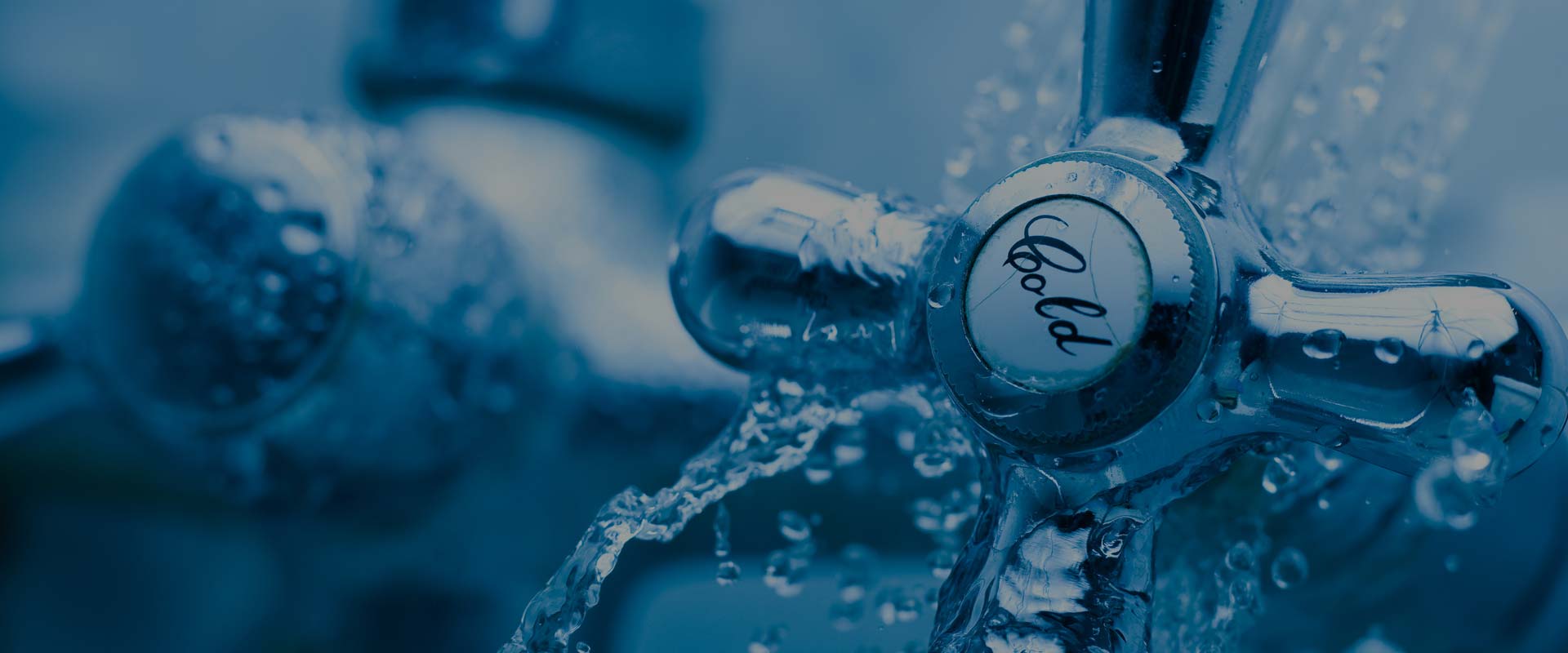 Cold tap with water droplets splashing